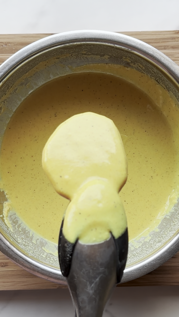 slice of potato being put into the batter for Afghan Pakawra